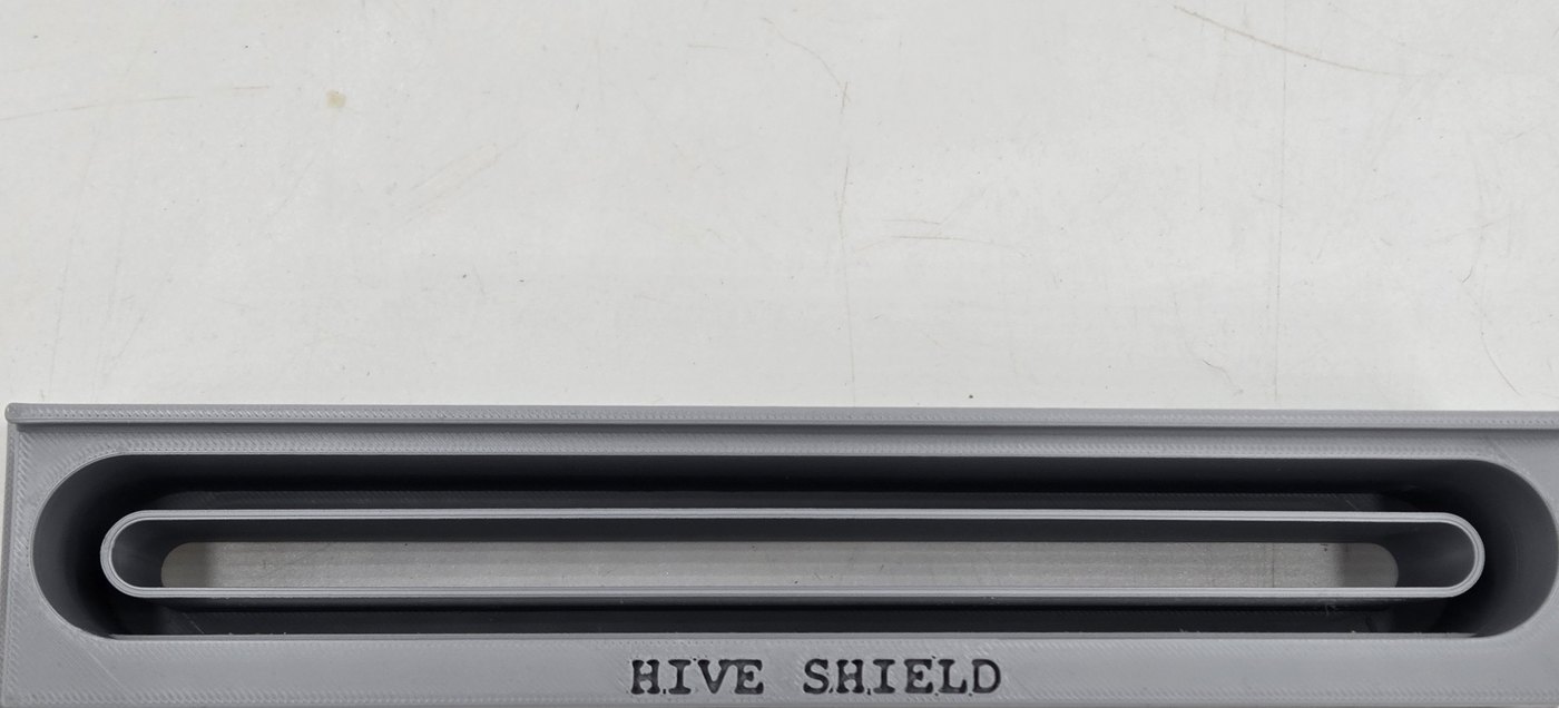 Close-up of the Hive Shield U-shaped channel that guides beetles into the trap